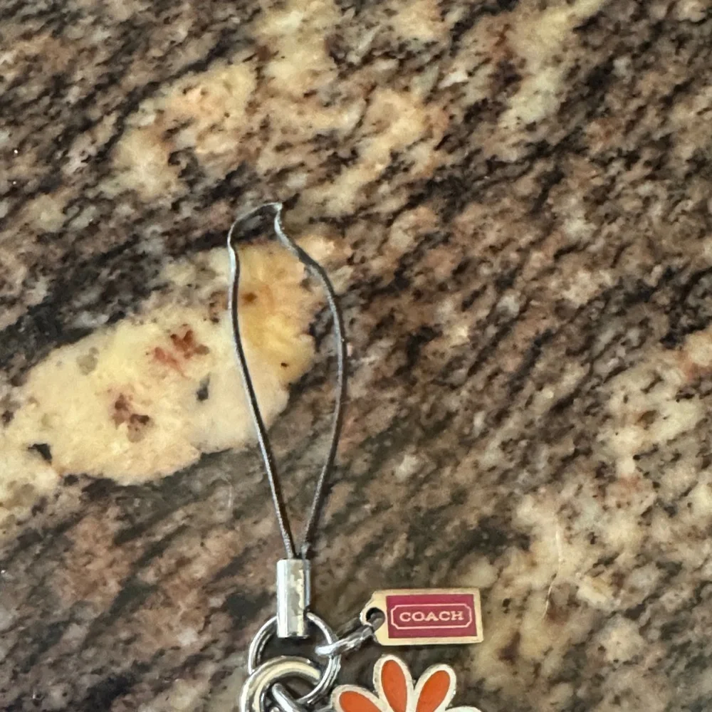 Coach White Wristlet with Orange Flower Phone Charm